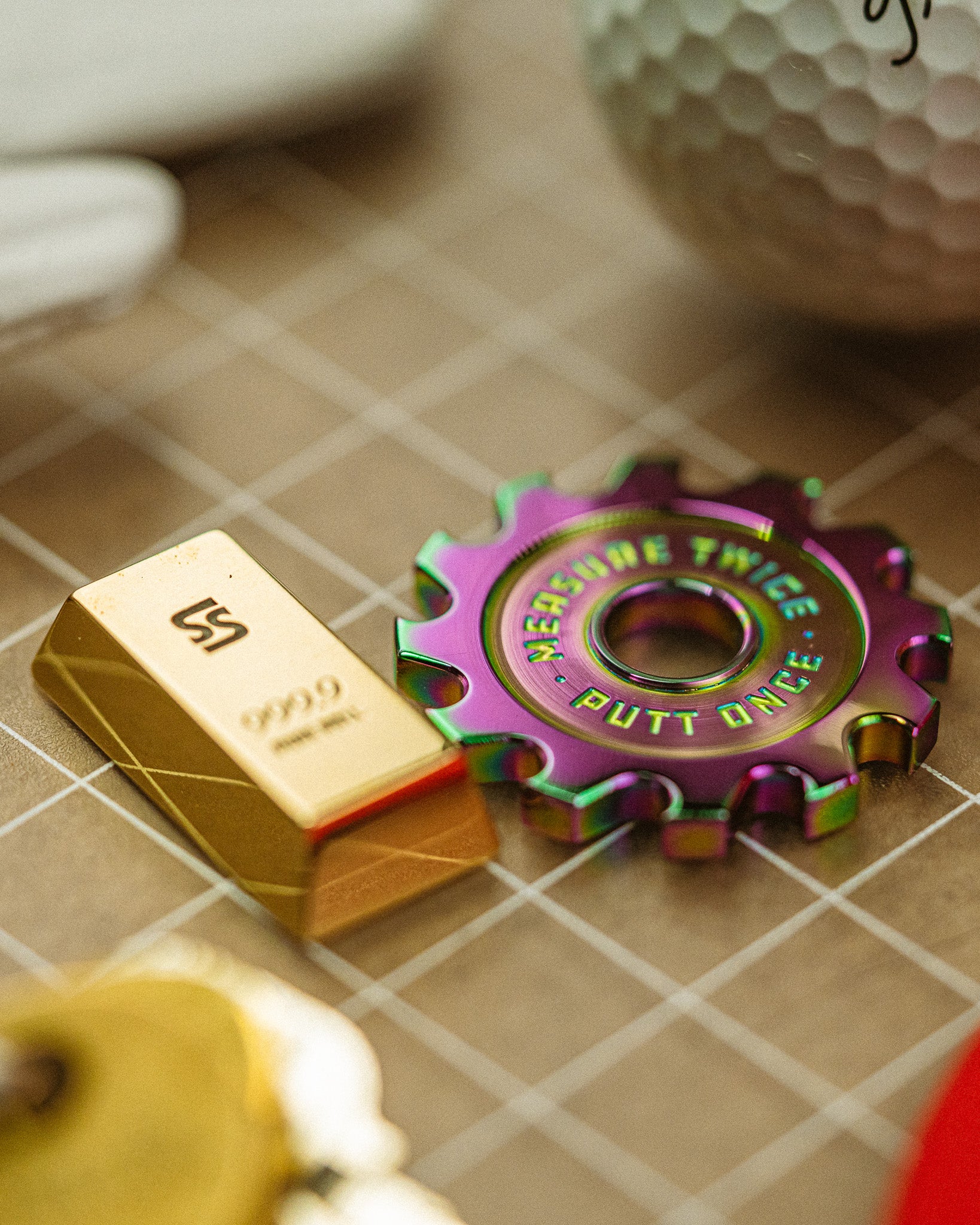 Smallswing Strike Gold Ball Marker next to our Eagle Blade Ball Marker